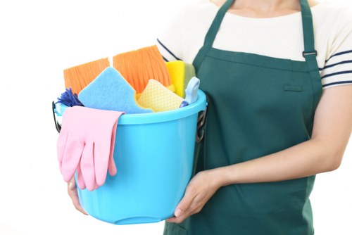 Cleaner preparing carpet cleaning equipment in a safe residential setting