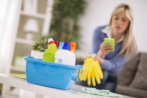 Protected cleaning operative using PPE while performing carpet cleaning tasks